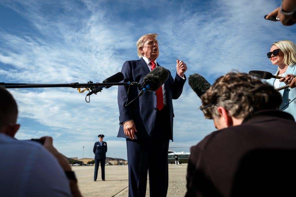 President Donald J. Trump speaks with members of the press before boarding Air Force One at Joint Base Andrews, Maryland, Friday, August 21, 2026. (Photo: White House/Flickr, by Molly Riley)