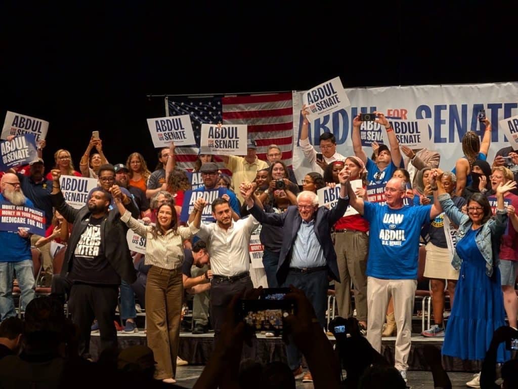 Michigan state Rep. Donavan McKinney (left) and Michigan Democratic Senate candidate Abdul El-Sayed (center) are joined by Rep. Alexandria Ocasio-Cortez, Sen. Bernie Sanders, UAW President Shawn Fain, and Rep. Rashida Tlaib at a rally in Detroit on July 20, 2026. (Photo: x.com/DonavanMI13)