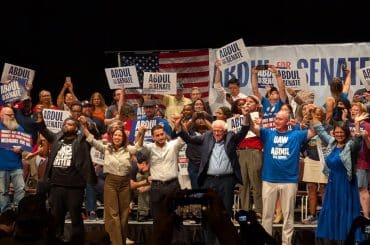 Michigan state Rep. Donavan McKinney (left) and Michigan Democratic Senate candidate Abdul El-Sayed (center) are joined by Rep. Alexandria Ocasio-Cortez, Sen. Bernie Sanders, UAW President Shawn Fain, and Rep. Rashida Tlaib at a rally in Detroit on July 20, 2026. (Photo: x.com/DonavanMI13)