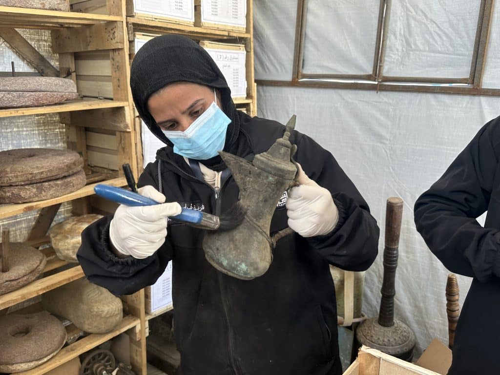 Members of the Heritage Guardians volunteer team, affiliated with the Mayasem Association for Culture and the Arts, examine and document historical artifacts recovered from beneath the rubble in Gaza, Khan Younis.(Photo: Yousef Abadla)