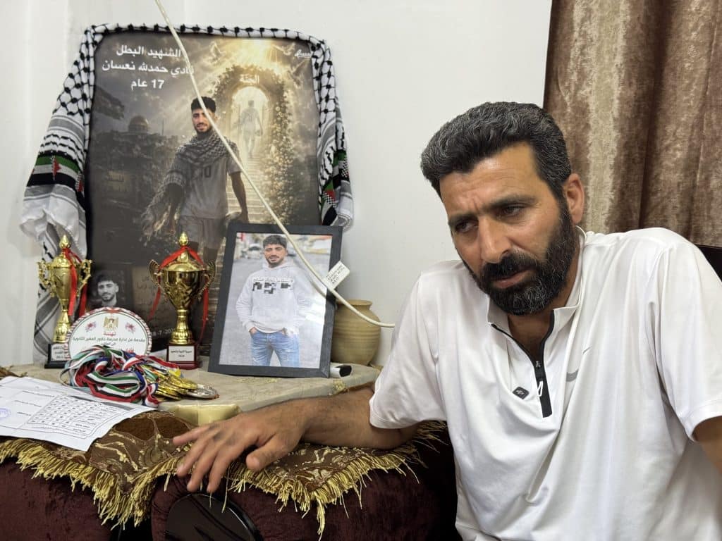 Hamdallah al-Na'san, father of martyred 17-year-old Fadi in al-Mughayyir, in front of paraphernalia belonging to his son. (Photo: Shatha Hammad)