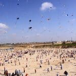Palestinian children fly kites along the beach during a U.N.-run summer camp in Gaza City on July 29, 2010. (Photo: Mohammed Asad/APA Images)