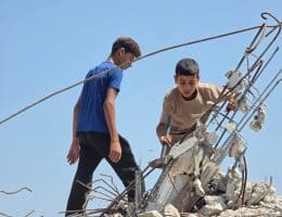 Abdulrahman and his brother go about demolishing their home and clearing its rubble. (Photo: Muhammad Eslayeh)