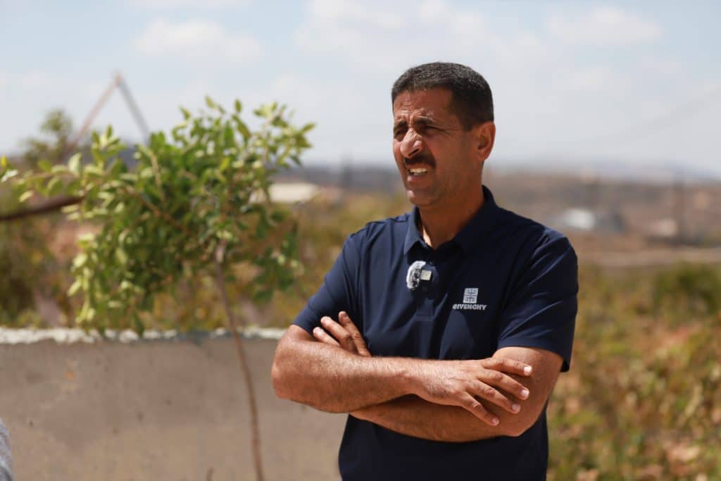 Abudul Azim Wadi, head of the Qusra village council, speaks to Mondoweiss amid the ongoing settler siege on Palestinians in Ras al-Ain hill near the West Bank Village, August 2026. (Photo: Shatha Hammad)