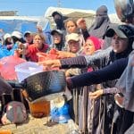 Palestinians receive meals from a community kitchen in al-Mawasi, Khan Younis, southern Gaza Strip, on September 4, 2026. (Photo: Tariq Mohammad/APA Images)