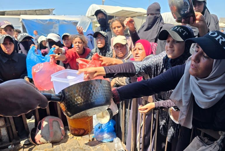 Palestinians receive meals from a community kitchen in al-Mawasi, Khan Younis, southern Gaza Strip, on September 4, 2026. (Photo: Tariq Mohammad/APA Images)