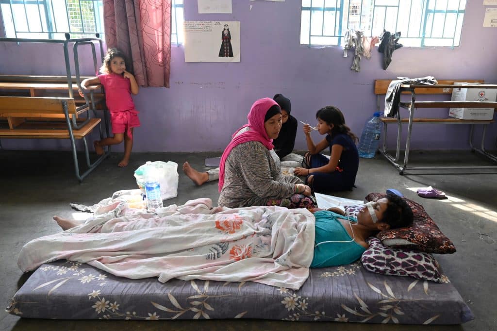 A Palestinian woman wounded during clashes between supporters of the Fatah movement and rival groups at Ain al-Hilweh Palestinian refugee camp rests in a classroom at an UNRWA school in Sidon, Lebanon, September 11, 2023. (Photo: © Wael Hamzeh/EFE via ZUMA Press/APA Images)
