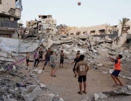 Children play volleyball on a makeshift court set up amid the rubble in Gaza City, September 16, 2026. (Photo: Bilal Osama/APA Images)