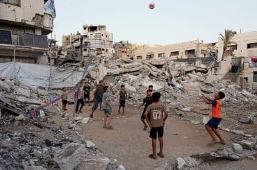 Children play volleyball on a makeshift court set up amid the rubble in Gaza City, September 16, 2026. (Photo: Bilal Osama/APA Images)