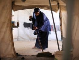 A Palestinian mother bathes her child inside a camp for displaced people in the al-Zawaida area of the central Gaza Strip, on June 17, 2026. Thousands of displaced families continue to endure harsh humanitarian conditions and extreme summer temperatures while living in tents that lack basic services and essential living conditions. (Hassan Jedi / apaimages)