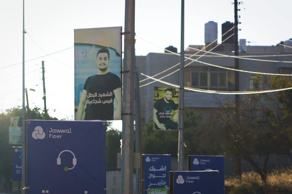 Portraits of Palestinians killed by the Israeli army or settlers along the road to the entrance of Deir Jarir. (Photo: Qassam Muaddi/Mondoweiss)