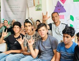 Fadl Kurraz with teachers and students at the educational sites. (Photo courtesy of the author)