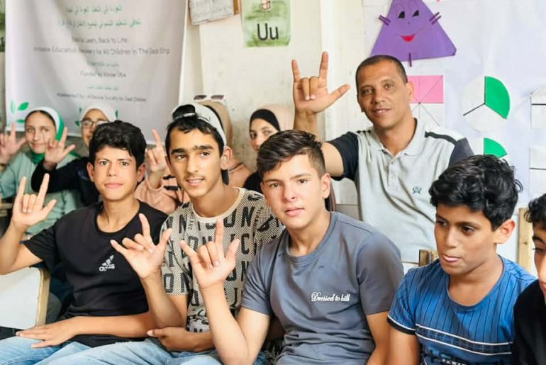 Fadl Kurraz with teachers and students at the educational sites. (Photo courtesy of the author)