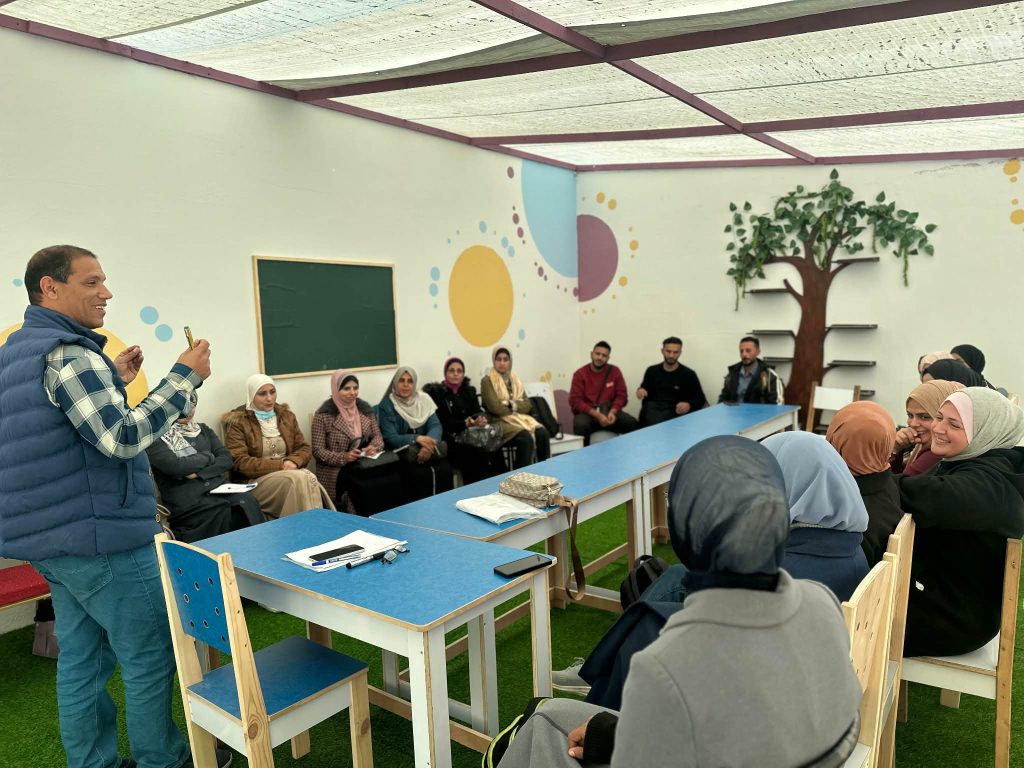 Fadl Kurraz with teachers and students at the educational sites. (Photo curtesy of the author)
