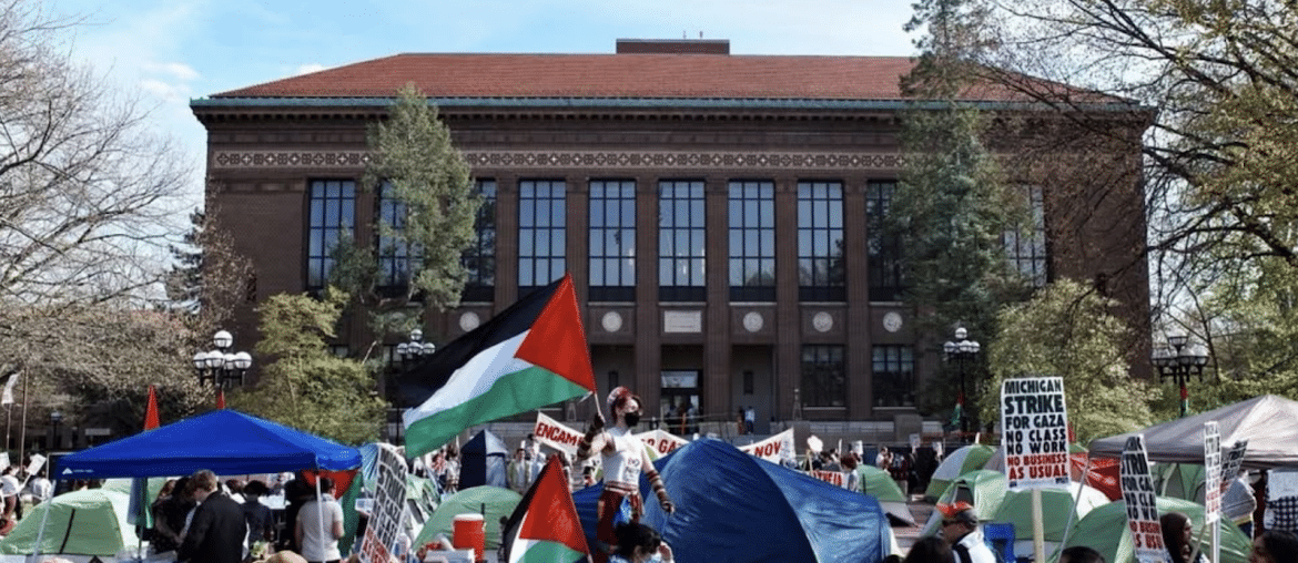 “The Gaza solidarity encampment at the University of Michigan, which was violently disbanded by UM police in May 2024. Photo by TAHRIR Coalition.”