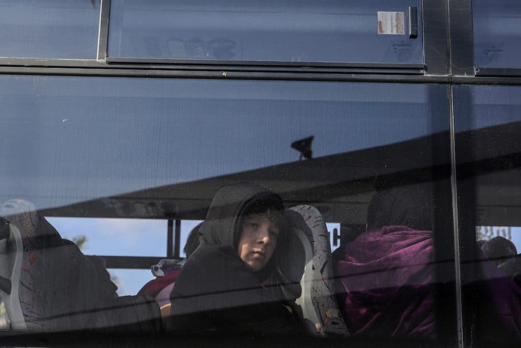 A Palestinian child looks out the window of a bus crossing into Egypt from the Gaza Strip through the Rafah border crossing, on February 6, 2024. (Photo: © Abed Rahim Khatib/DPA via ZUMA Press/APA Images)