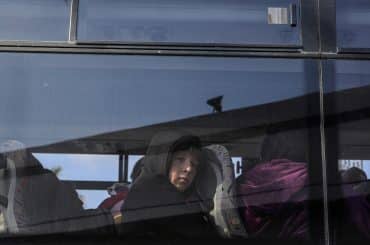 A Palestinian child looks out the window of a bus crossing into Egypt from the Gaza Strip through the Rafah border crossing, on February 6, 2024. (Photo: © Abed Rahim Khatib/DPA via ZUMA Press/APA Images)
