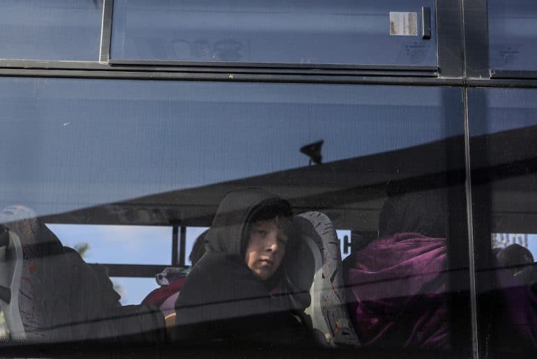 A Palestinian child looks out the window of a bus crossing into Egypt from the Gaza Strip through the Rafah border crossing, on February 6, 2024. (Photo: © Abed Rahim Khatib/DPA via ZUMA Press/APA Images)