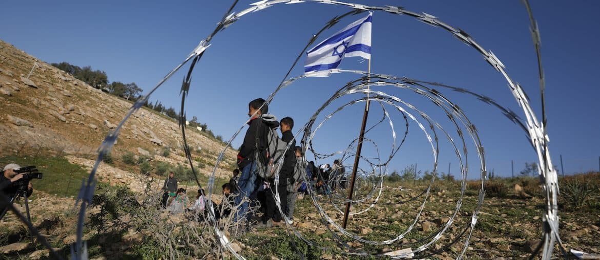 Israeli settlers block the main road leading to schools in Khirbet Umm al-Khair, near Hebron, in the southern West Bank, by erecting a fence, hindering students' access to education due to the lack of safe alternative routes. Hebron, West Bank, April 14, 2026. (Photo by Mamoun Wazwaz/ apaimages)