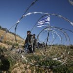 Israeli settlers block the main road leading to schools in Khirbet Umm al-Khair, near Hebron, in the southern West Bank, by erecting a fence, hindering students' access to education due to the lack of safe alternative routes. Hebron, West Bank, April 14, 2026. (Photo by Mamoun Wazwaz/ apaimages)