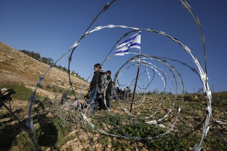 Israeli settlers block the main road leading to schools in Khirbet Umm al-Khair, near Hebron, in the southern West Bank, by erecting a fence, hindering students' access to education due to the lack of safe alternative routes. Hebron, West Bank, April 14, 2026. (Photo by Mamoun Wazwaz/ apaimages)