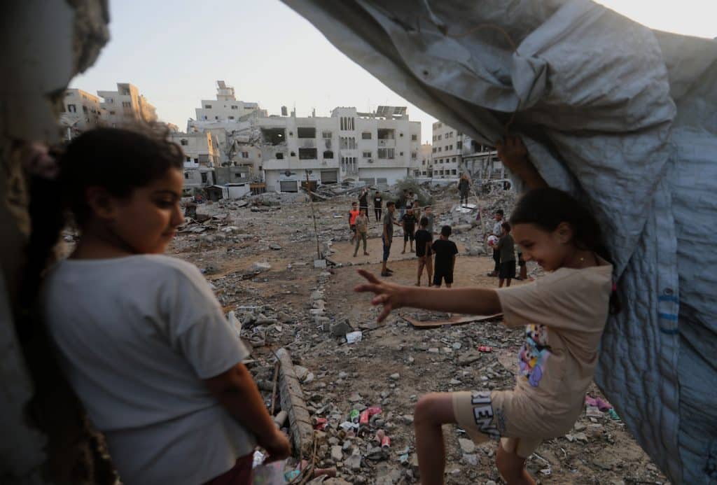 Palestinian children play volleyball on a court set up among the ruins of buildings destroyed in the war in Gaza City on September 16, 2026. (Photo: Bilal Osama/APA Images)